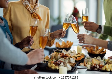 Close-up of business colleagues toasting with Champagne while having a party in the office.  - Shutterstock ID 1837391293
