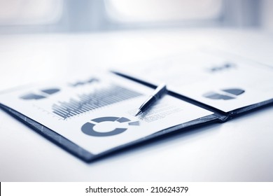 A Closeup Of A Business Financial Chart With Bar And Pie Graphs. A Pen Is On Top. Can Be Used To Represent Business Expenses, Growth Or Revenue.