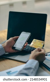 Close-up Of Business Holding Credit Card To Check Account Balance Use An Online Banking App On Your Laptop. Online Payment Typewriter Hand Shopping Keyboard On The Notebook