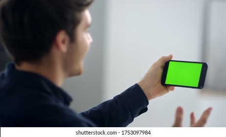 Closeup Business Man Making Video Call On Smartphone In Slow Motion. Close Up Of Businessman Making Video Chat On Green Screen Mobile Phone. Male Professional Waving Hands After Conference Call.