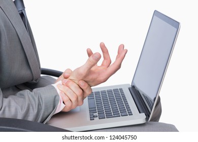 Close-up Of Business Man With Wrist Pain While Using Laptop Over White Background