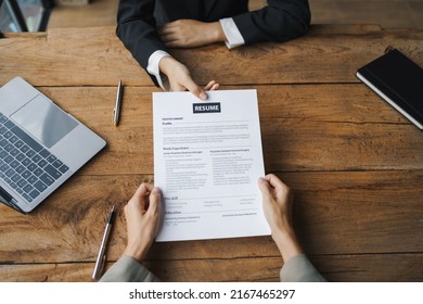 Close-up Of Business Owner Check Resume Of Job Applicants In Company At The Office.