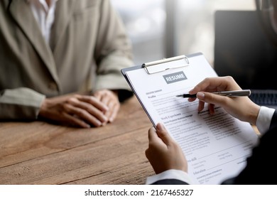 Close-up Of Business Owner Check Resume Of Job Applicants In Company At The Office.