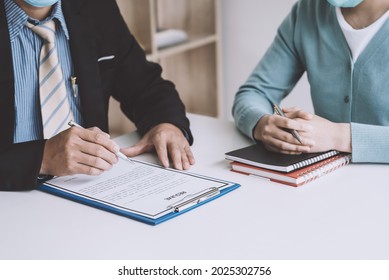 Close-up Of Business Owner Hand Holding A Pen To Check Resumes Of Job Applicants At The Office.