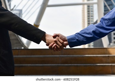 Close-up of business people handshaking 