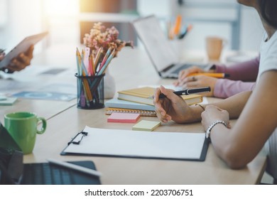 Close-up of business people taking note at a meeting on clipboard for drafting, writing meeting minutes in office and printing on computer. - Shutterstock ID 2203706751