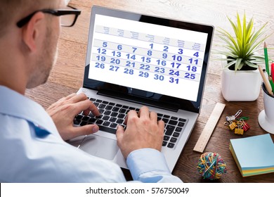 Close-up Of A Business Person Looking At Calendar With Daily Agenda On Laptop Computer