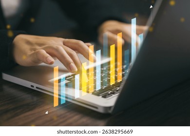 A close-up of a business person typing on a laptop with a digital bar chart overlay, symbolizing data analytics, business growth, and modern financial technology.
