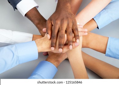 Closeup of business team putting their hands on top of each other