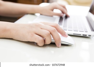 Closeup Of Business Woman Hand Typing On Laptop Keyboard With Mouse