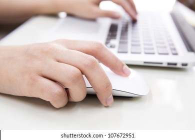 Closeup Of Business Woman Hand Typing On Laptop Keyboard With Mouse