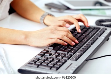 Closeup of business woman's hand typing on computer keyboard