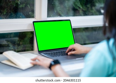 Close-up of businessfemale wearing smartwatch casual working with laptop computer with empty green screen and book with coffee cup and smartphone in at the cafe, Business Lifestyle communication - Powered by Shutterstock