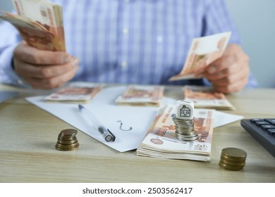 Close-up of businessman counting money at table in office. Business concept - Powered by Shutterstock