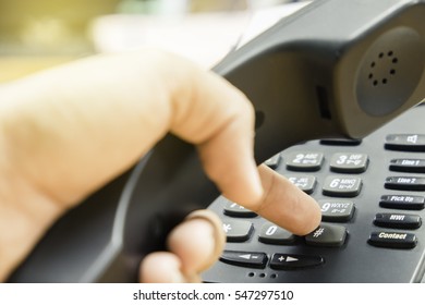 Closeup Of Businessman Dialing Number On Telephone Keypad