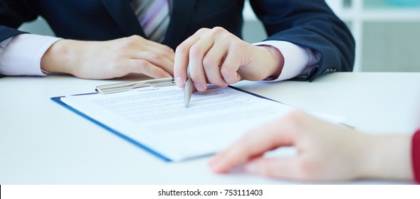 Closeup Of Businessman Explaining  To His New Business Partner The Terms Of The Agreement Or Contract. With Depth Of Field Image.