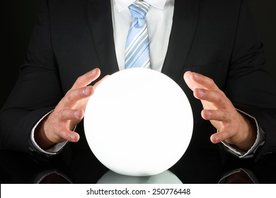 Close-up Of Businessman Hand On Crystal Ball