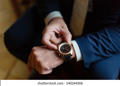 Closeup With Businessman Hands Closing Elegant Blue Suit Jacket And Wearing Banker Expensive Wrist Watch