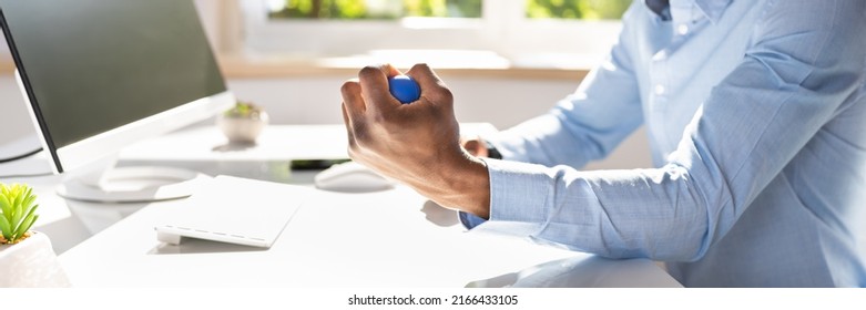 Close-up Of Businessman Holding Stress Ball In Hand