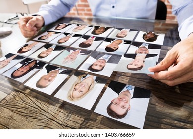 Close-up Of A Businessman Making Candidate Selection Over The Desk At Workplace