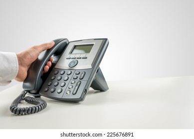 Closeup Of Businessman Making A Phone Call On Landline Telephone. Conceptual Of Customer Service Or Telemarketing.