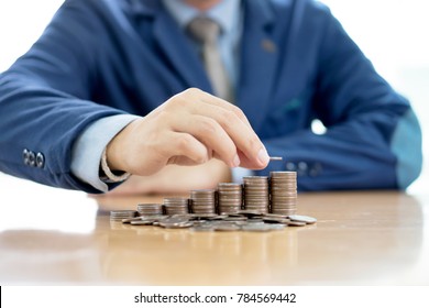 Close-up Of A Businessman Making Stack Of Coins - Shutterstock ID 784569442