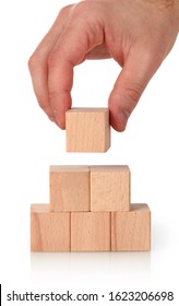 Closeup of businessman making a wooden blocks pyramid - Shutterstock ID 1623206698