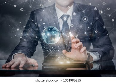 A closeup of businessman operating with global networking system of wireless connections with human images models and a globe above tablet on the table. The concept of global social networking system. - Powered by Shutterstock