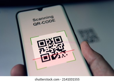 Close-up Of Businessman Scanning A Barcode Using Cell Phone