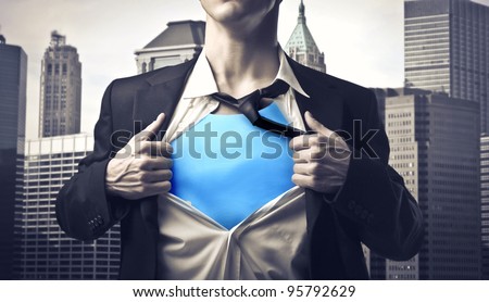 Closeup of a businessman showing the superhero suit under his shirt