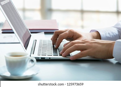 Closeup of businessman typing on laptop computer - Powered by Shutterstock