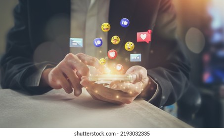 Close-up of businessman using smartphone sending emojis. - Powered by Shutterstock