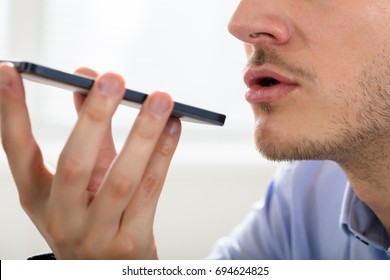 Close-up Of A Businessman Using Voice Assistant On Mobile Phone