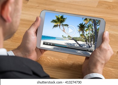 Close-up Of Businessman Watching Video On Digital Tablet At Desk - Shutterstock ID 413274730