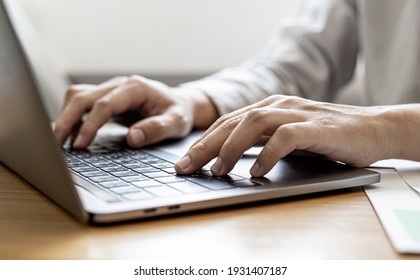 Close-up A businessman working in a private room, He is typing on a laptop keyboard, He uses a messenger to chat with a partner. Concept of using technology in communication. - Shutterstock ID 1931407187
