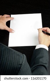 Close-up Of A Businessman Writing, Shot From Over The Shoulder.