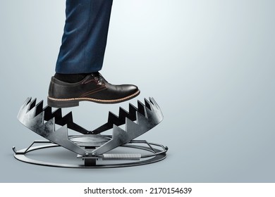 Close-up of a businessman's foot over a bear trap. The concept of problem solving, failure, crisis, crisis management, mixed media - Shutterstock ID 2170154639