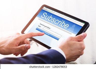 Close-up Of A Businessman's Hand Filling Online Subscription Form