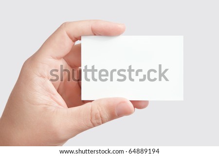 Closeup of businessman's hand holding blank white paper business card for your message (copy space), isolated on gray background