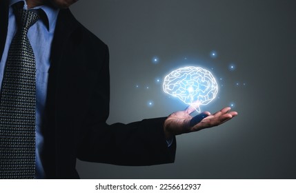Close-up of businessman's hand holding brain in palm, Virtual reality man with symbol neurons in the brain. Concept of idea and innovation, business concept. - Shutterstock ID 2256612937