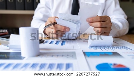 Close-up of businessman's hands collecting bills for tax refund and tax savings, finance banking and savings ideas,