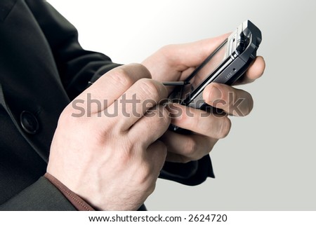 Closeup of a businessman's hands with a pocketpc, isolated