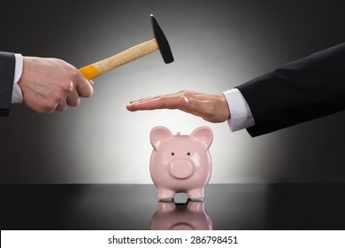 Close-up Of Businessman's Hands Saving Piggybank From Hammering - Shutterstock ID 286798451
