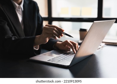 Close-up Businessperson Typing And Searching Data Internet On Laptop       , Graph Diagram,  And Calculator On Office Table, Online Learning Concept.