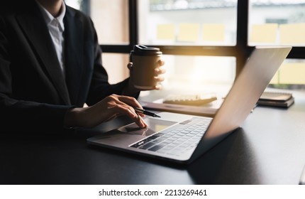 Close-up Businessperson Typing And Searching Data Internet On Laptop       , Graph Diagram,  And Calculator On Office Table, Online Learning Concept.