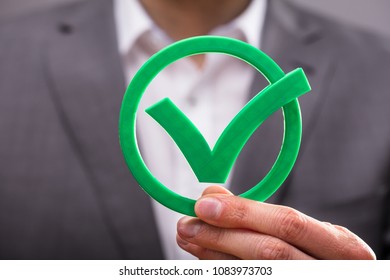 Close-up Of A Businessperson's Hand Holding Green Check Mark Icon - Shutterstock ID 1083973703