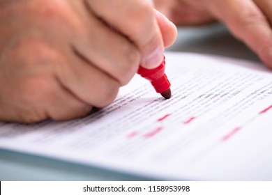 Close-up Of A Businessperson's Hand Marking Error With Red Marker - Powered by Shutterstock