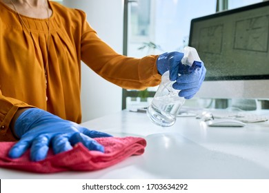 Close-up of businesswoman cleaning her desk while working in the office.