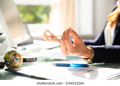 Close-up Of A Businesswoman's Hand Meditating In Office - Powered by Shutterstock