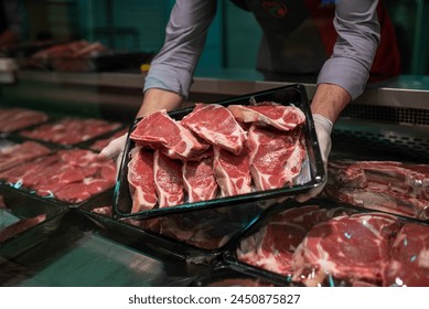 Closeup of butcher's hands holding meat piece in shop - Powered by Shutterstock